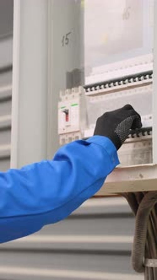 African American Electrician Installing an Electrical Panel