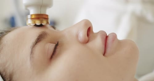 Woman Receives Cosmetic Treatment on Forehead