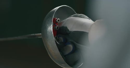 Cinematic slow motion close up a fencer with professional equipment is practising assaults of fenc