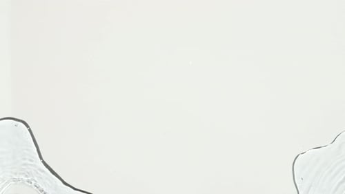 Water Moving Across White Surface