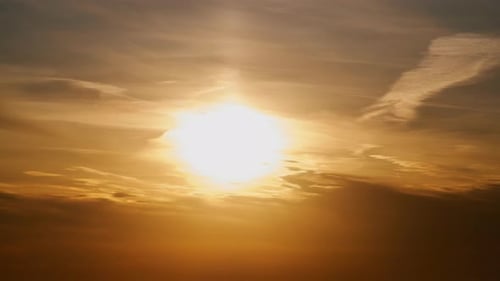 Golden Sky with Glowing Sunlight and Clouds