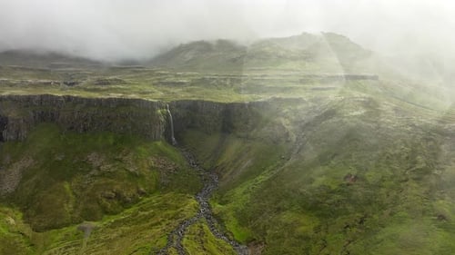 Small Waterfall Mountain River Falls From a Huge Cliff Beautiful Aerial View in Summer Season The