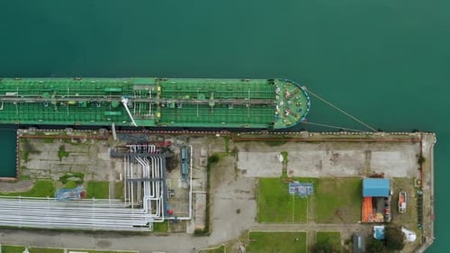 Aerial Top Down View Oil Ship Tanker Vessel Loading in Gas and Oil Terminal Station Refinery Global