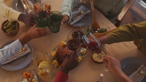 People Clinking Glasses at Family Dinner Top View