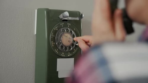 Closeup of a Woman Dialing a Number on a Vintage Rotary Telephone The Scene Represents Classic