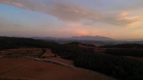 Beautiful countryside landscape at sunrise. Hills cultivate with Wines. Beautiful Monserrat Mountain