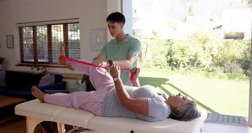 Man Assisting Senior Woman with Physical Therapy