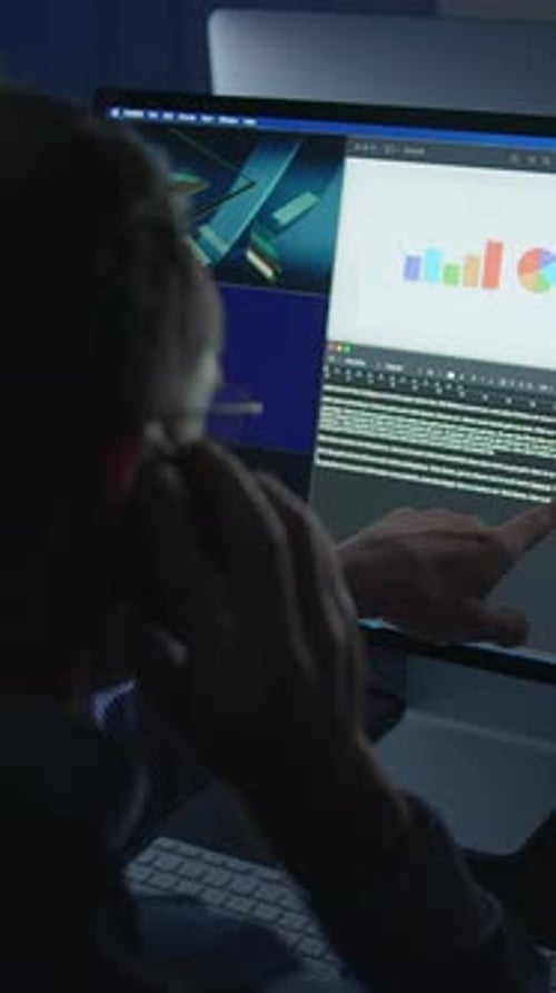 Man At Computer on Cell Phone at Night