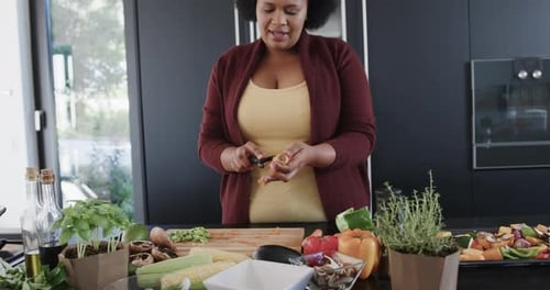 Woman Peeling Carrot in Modern Kitchen