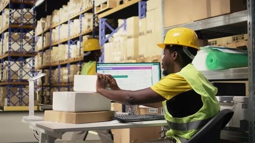 Warehouse Worker Scanning Packages for Delivery
