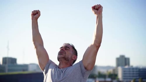 Victorious Man With Arms Raised in City