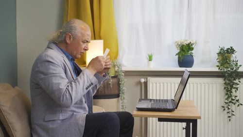 Man Working on Laptop at Home