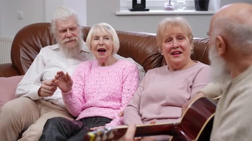 Senior Friends Sing and Play Guitar Together