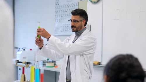 Chemistry Teacher Performing Experiment in Laboratory for Students