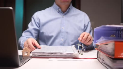 Accountant Organizing Documents and Managing Real Estate Investments