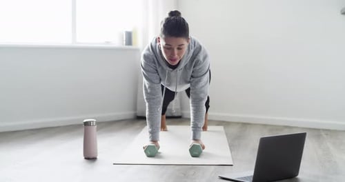 Woman Working Out with Dumbbells at Home