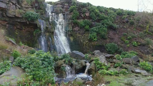 Aerial drone footage of a tall rocky waterfall in the Yorkshire Dales, Pennies. Moorland scene of a