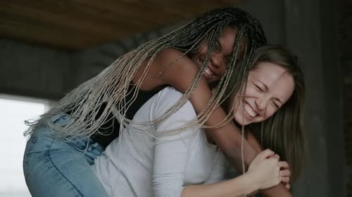 Happiness Hugs and Laughter of a Multiethnic Homosexual Couple Emotional Portrait of a Lesbian