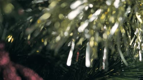 Decorations and lights on a Christmas tree. Close up, dolly shot.