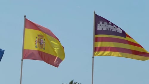 Spanish and Balearic Islands Flags Flapping in Wind