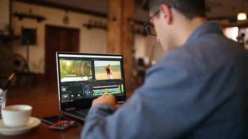 El editor de vídeo Freelancer funciona en el ordenador portátil con el software de edición de películas Videógrafo Vlogger