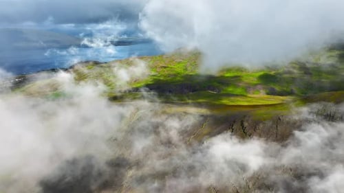 Flying Through Clouds Above Green Hills Paradise Heaven Mountain Range with High Peaks Wonderful
