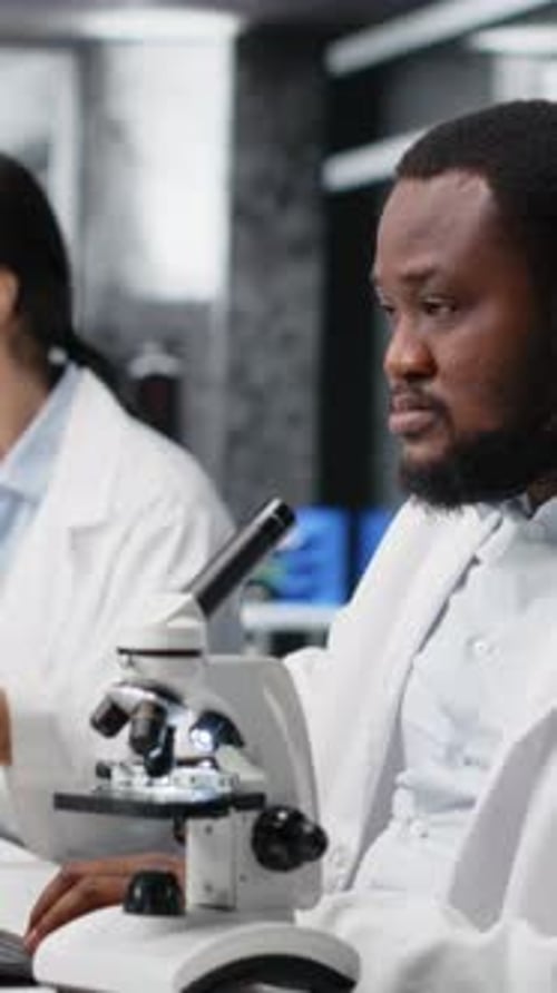 Scientist Using Microscope in Laboratory for Research