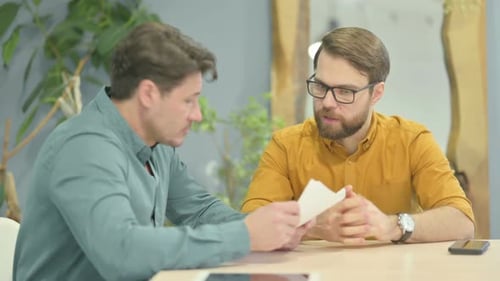 Business People Discussing Paperwork in Office