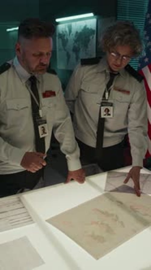 Adults Reviewing Map at Command Center