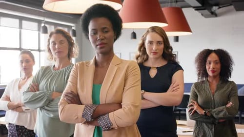 Portrait of confident diverse businesswomen standing in office with arms crossed, in slow motion