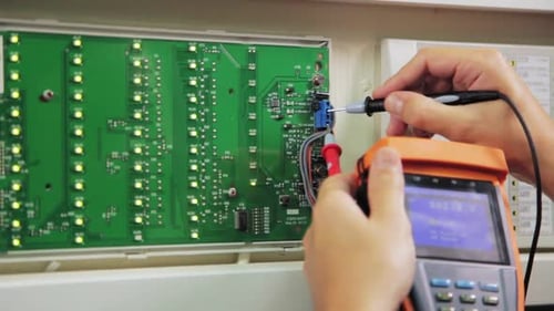 Electrician Checks Circuit with Meter at Substation Closeup