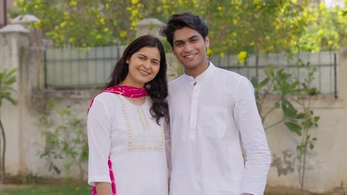 Indian Couple giving Side Hug and Looking in the Camera