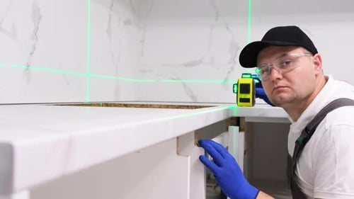 A Worker Installs Furniture in the Kitchen