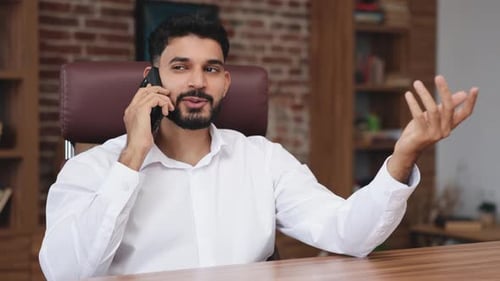 Young Adult Talking on the Phone at Work