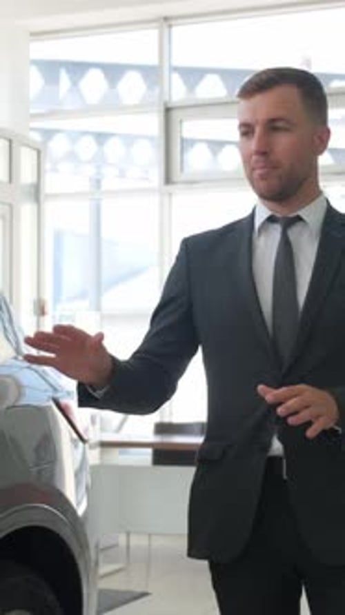 A Manmanager of a Car Salon Talks About New Cars Sale of Cars in the Dealership Vertical Video