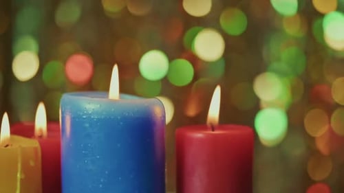 Colorful Candles Burning with Bokeh Lights Background