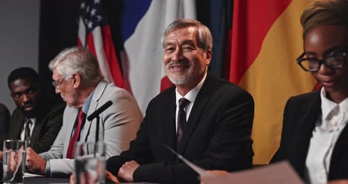 Diverse Group Attending Meeting with Flags Background