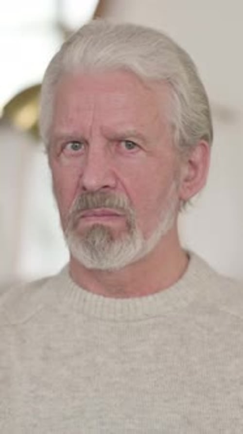 Senior Man Stares Seriously at the Camera