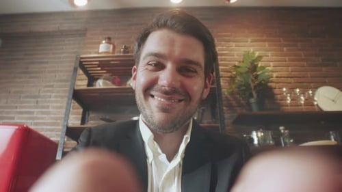 Friendly Man Setting Webcam Casual Professional Man in Cozy Cafe Finetunes His Remote Meeting Camera