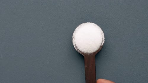 Spoons with Sugar and Salt on Gray Background
