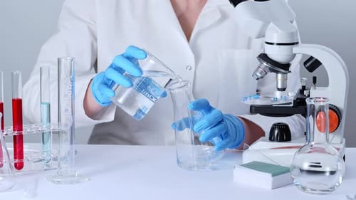 Scientist Pours Liquid in Lab Environment