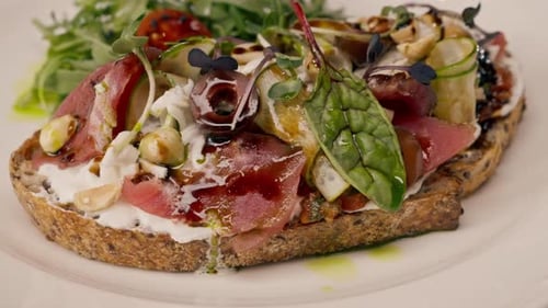 Close-up of bruschetta with jamon and cream cheese cooked in the professional kitchen