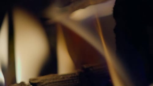 Slow motion shot of flames and embers in a fireplace
