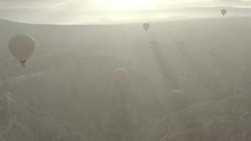 Aerial video of hot air balloons at sunrise, iconic destination behind Cappadocia Turkey