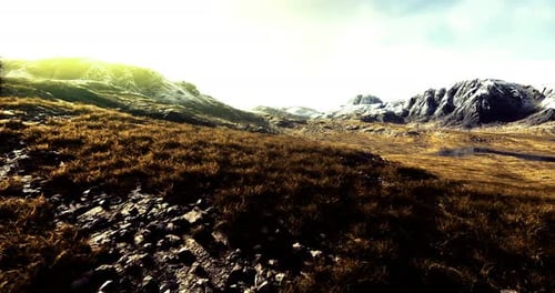 Majestic Mountain Landscape with Grass and Rocky Terrain Under a Bright Sky