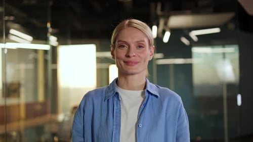 Blonde Woman Gives a Thumbs Up in Office