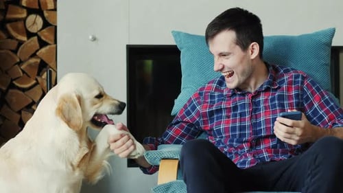 A Young Man Playing with His Dog Making Funny Faces at Each Other A Funny Pet Video