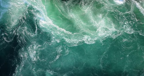 Blue waves of water of the river and the sea meet each other during high tide and low tide.