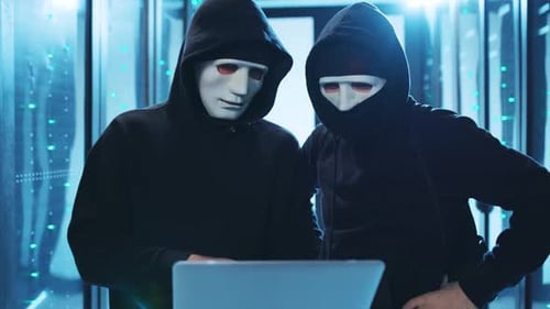 Hooded Figures Hacking Servers at Night
