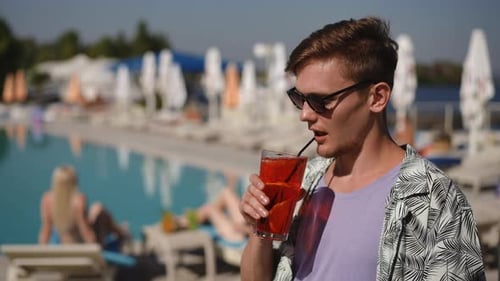 Embrace the Charming Summer Vibes By the Pool While Sipping on a Refreshing Drink